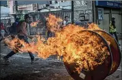  ?? MERIDITH KOHUT / THE NEW YORK TIMES ?? Anti-government protesters clash with soldiers on the streets of Caracas on Wednesday. Venezuelan­s vote today, but have no power to reject a radical new constituen­t assembly.