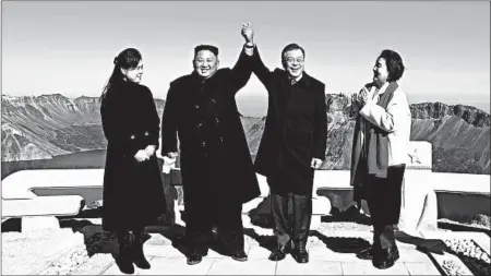  ?? PYONGYANG PRESS CORPS ?? North Korea’s Kim Jong Un and his wife, Ri Sol Ju, left, with South Korea’s President Moon Jae-in and his wife, Kim Jung-sook, on top of Mount Paektu in North Korea on Thursday.