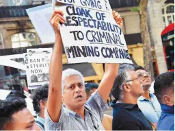  ??  ?? OTHER SCENES from the protest. The poster below references the chimney that collapsed in Vedanta’s BALCO plant in Korba, Chhattisga­rh, in 2009.