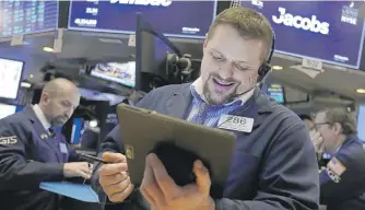  ?? RICHARD DREW/AP ?? Trader Michael Milano works at the New York Stock Exchange on Wednesday.