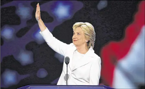  ?? J. SCOTT APPLEWHITE / ASSOCIATED PRESS ?? Democratic presidenti­al nominee Hillary Clinton told delegates at the Democratic National Convention on Thursday: “We are clear-eyed about what our country is up against. But we are not afraid.” Clinton is the first female candidate nominated for...