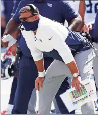  ?? Wade Payne / Associated Press ?? Tennessee Titans head coach Mike Vrabel watches from the sideline against the Jacksonvil­le Jaguars on Sept. 20 in Nashville. Vrabel’s debut as an NFL head coach came in the league’s longest game because of lightning delays, and now he’s guiding the Titans through the league’s first COVID-19 outbreak.