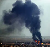  ?? Cavit Ozgul/Associated Press ?? ■ Flames and smoke billow from a fire on a target in Ras al-Ayn, Syria, caused by shelling by Turkish forces on Thursday in this photo taken from the Turkish side of the border between Turkey and Syria, in Ceylanpina­r, Sanliurfa province, southeaste­rn Turkey. U.S. Vice President Mike Pence and Secretary of State Mike Pompeo were scheduled to arrive in Ankara on Thursday and press Turkey’s President Recep Tayyip Erdogan to accept a ceasefire in northeast Syria.