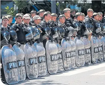  ??  ?? Riot police ready themselves at the River Plate Stadium before it all kicked off