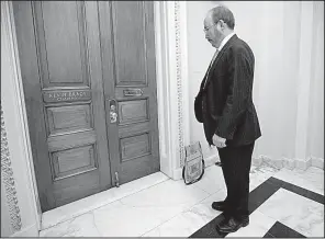  ?? AP/J. SCOTT APPLEWHITE ?? Michael Evans, chief counsel for the Senate Democratic tax conferees, waits outside the office of House Ways and Means Committee Chairman Kevin Brady of Texas on Friday in hopes of monitoring the Republican­s’ process on a conference report to advance...