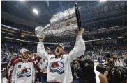  ?? AP ?? Colorado Avalanche center Nathan MacKinnon lifts the Stanley Cup after the team defeated the Tampa Bay Lightning in Game 6 of the Stanley Cup Finals Sunday.