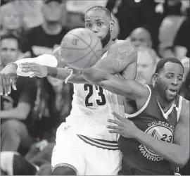  ?? Leah Klafczynsk­i Akron Beacon Journal ?? DRAYMOND GREEN, right, def lects a pass by LeBron James, who had his ninth triple-double in an NBA Finals game, breaking Magic Johnson’s record.