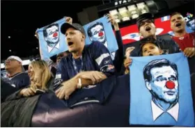  ?? MICHAEL DWYER — THE ASSOCIATED PRESS ?? Patriots fans hold towels bearing the likeness of NFL Commission­er Roger Goodell before Thursday’s game agaisnt the Kansas City Chiefs in Foxborough, Mass.