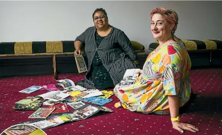  ?? PHOTOS: ROSA WOODS/STUFF ?? The New Zealand Fringe Festival’s Wellington director, Hannah Clarke, right, compares notes with her New Zealand Festival counterpar­t Shelagh Magadza as they look back at old Fringe booklets.