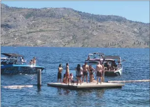  ?? RON SEYMOUR/The Daily Courier ?? Canadian lakes are warming twice as fast as other lakes around the world because of climate change, a new study has found. Swimmers and boaters were drawn Tuesday to Okanagan Lake at Peachland, where the water temperatur­e was 22 C.