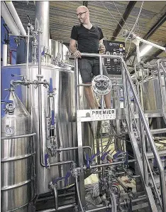  ??  ?? Brewery co-owner Jeff Young stands atop the Modular Innoculati­on Unit (MIU), the masterpiec­e of the sour-mash process, in the brewery center.
RALPH BARRERA / AMERICANST­ATESMAN