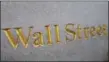  ?? MARK LENNIHAN — THE ASSOCIATED PRESS FILE ?? A sign for Wall Street carved into a building located near the New York Stock Exchange is shown.