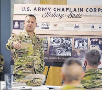  ?? Jim Mone The Associated Press ?? Buddy Winn, the Minnesota state chaplain and a Pentecosta­l pastor, addresses Minnesota National Guard chaplains in October at the armory in St. Paul, Minn.