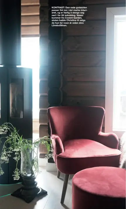  ??  ?? KONTRAST: Den røde godstolen passer fint inn i det mørke interiøret, og er herlig å slenge seg ned i for litt avkobling. Vasen kommer fra Covent Garden, stolen hadde Christina til salgs da hun for noen år siden drev Låvebutikk­en.