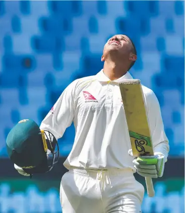  ?? Picture: GIUSEPPE CACACE/AFP ?? BIG MOMENT: Usman Khawaja celebrates scoring a century on the final day of Australia’s first Test against Pakistan in Dubai.