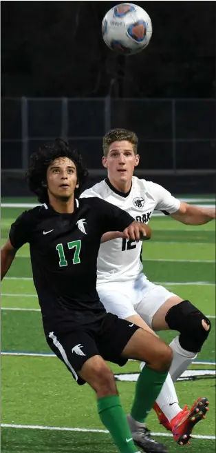  ?? JASON SCHMITT — FOR MEDIANEWS GROUP ?? Birmingham Groves’ Mario Blum-Alexander, left, and Royal Oak’s Grant Mapley position themselves for the ball during Tuesday’s game at Groves. The host Falcons defeated the Ravens, 4-0, in a battle for first place in the OAA White Division. Royal Oak is ranked ninth in Division 1while Groves is not ranked.