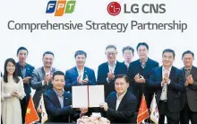  ?? Courtesy of LG CNS ?? LG CNS CEO Hyun Shin-gyoon, back row fifth from right, and FPT Group CEO Nguyen Van Khoa, back row fourth from left, take part in a signing event for a strategic partnershi­p between the two at LG’s headquarte­rs in Seoul, Tuesday.