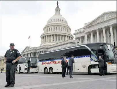  ?? The Associated Press ?? BUS TRIP: Sen. John Kennedy, R-La., second from right, boards a bus Wednesday on Capitol Hill in Washington heading to the White House with other Senators to get a briefing on North Korea.