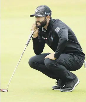  ?? PETER MORRISON/THE ASSOCIATED PRESS ?? Adam Hadwin of Abbotsford, B.C., looks over a putt during second-round action at the British Open on Friday. Hadwin had a 70 to sit in a tie for 40th place at the midway point.