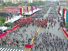  ??  ?? The parade scattered and Maduro, top left, was surrounded by protective shields, top