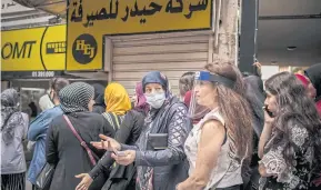  ?? NYT ?? A crowd waits outside of an exchange shop to purchase dollars as the local currency implodes in Beirut last month.