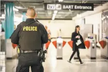  ?? Amy Osborne / Special to The Chronicle 2019 ?? BART’s budget would stress social services rather than law officers, such as this one watching for fare evaders last year.