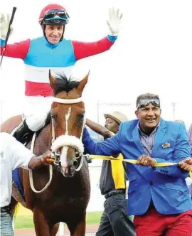  ??  ?? COLOURFUL CHARACTER. Owner Alesh Naidoo, pictured leading Love Struck (Anton Marcus) into the winner’s enclosure after the horse’s victory in the Grade 1 SA Classic in 2013, has protested strongly against 20-20 night racing at Greyville.