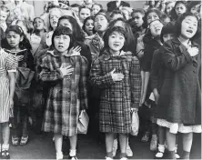  ??  ?? Above: Helene Nakamoto Mihara (left) and Mary Ann Yahiro (center) recite the Pledge of Allegiance in S.F. before being sent to an internment camp in 1942. Right: “Last West, Gas Station, Kern County, California,” was taken in 1938.