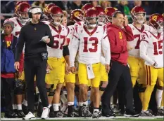  ?? MICHAEL REAVES — GETTY IMAGES ?? USC coach Lincoln Riley, left, and QB Caleb Williams (13) look on from the sideline during Saturday night's loss to Notre Dame in South Bend, Indiana.