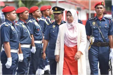  ??  ?? Zuraida (second right) inspects the guard of honour during her visit to the Fire and Rescue Department station at Seri Manjung. — Bernama photo