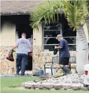  ?? DAVID GOODHUE dgoodhue@miamiheral­d.com ?? Miami-Dade County firefighte­rs on Wednesday enter a Homestead house that caught fire the day before.