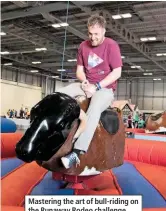  ??  ?? Mastering the art of bull-riding on the Runaway Rodeo challenge.