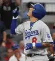  ?? JOHN AMIS - THE ASSOCIATED PRESS ?? Los Angeles Dodgers’ Manny Machado (8) celebrates his threerun homer against the Atlanta Braves during the seventh inning in Game 4 of baseball’s National League Division Series in Atlanta.