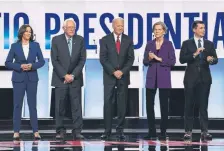  ?? Saul Loeb, AFP/Getty Images ?? From left, California Sen. Kamala Harris, Vermont Sen. Bernie Sanders, former Vice President Joe Biden, Massachuse­tts Sen. Elizabeth Warren and South Bend, Ind., Mayor Pete Buttigieg arrive for the Democratic primary debate Tuesday in Ohio.