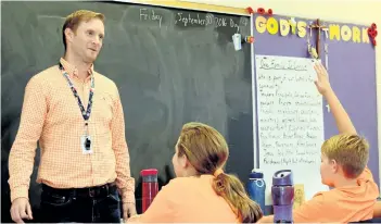  ?? MICHELLE ALLENBERG/POSTMEDIA NETWORK ?? Alexander Kuska Catholic Elementary School Grade 6 teacher Matthew Brady talks to his class about residentia­l schools and the importance of Orange Shirt Day.