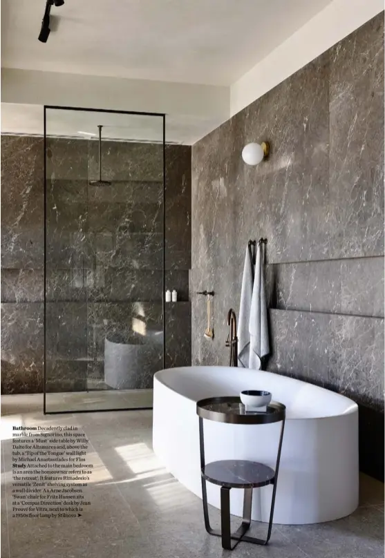  ??  ?? Bathroom Decadently clad in marble from Signorino, this space features a ‘Must’ side table by Willy Dalto for Altamarea and, above the tub, a ‘Tip of the Tongue’ wall light by Michael Anastassia­des for Flos Study Attached to the main bedroom is an area the homeowner refers to as ‘the retreat’. It features Rimadesio’s versatile ‘Zenit’ shelving system as a wall divider. An Arne Jacobsen ‘Swan’ chair for Fritz Hansen sits at a ‘Compas Direction’ desk by Jean Prouvé for Vitra, next to which is a 1950s floor lamp by Stilnovo