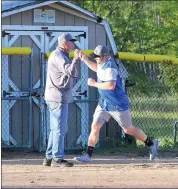  ?? Photo by Rich Quiggle ?? St. Marys Insurance’s Kenny Vogt is congratula­ted by coach Mike Cortina after hitting one of his two home runs Tuesday night against Tyler Landscape. Vogt’s second home run was a walk-off 2-run shot to lift SMI to a 12-11 win.