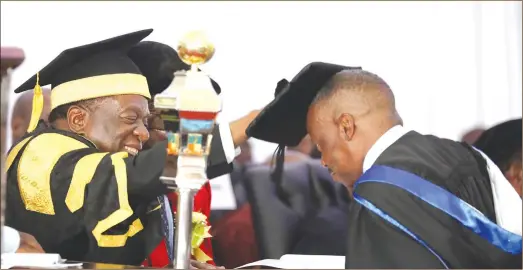  ??  ?? Midlands State University Chancellor President Mnangagwa, who is Chancellor of all State universiti­es in Zimbabwe, caps Air Force of Zimbabwe Commander Air Marshal Elson Moyo, who graduated with a Masters Degree in Internatio­nal Relations in Gweru yesterday. —(Picture by Eliah Saushoma)