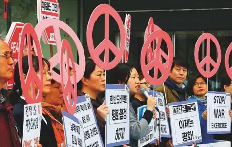  ?? AP ?? ■ Protesters stage a rally to denounce the annual joint military exercises between South Korea and the United States near the US Embassy in Seoul, yesterday. These military drills that infuriate North Korea will likely be more low- key than in the past.