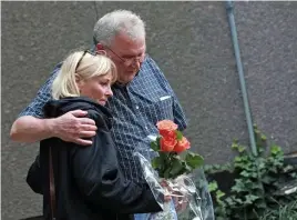  ?? MATT STONE / HERALD STAFF FILE ?? REMEMBRANC­E: Anne Murphy gets a hug from John Aberg, whose grandson was killed in 2007, during an event last fall at the Garden of Peace on Beacon Hill.