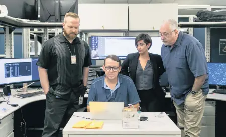  ?? MATIAS J. OCNER mocner@miamiheral­d.com ?? Left to right: Miami-Dade Police Lt. Jordan Fried, Officer Tracy Tompkins, Sgt. Bridget Doyle and Maj. George Perera, all with the South Florida Cyber Crimes Task Force, inspect an electronic skimmer at their office.