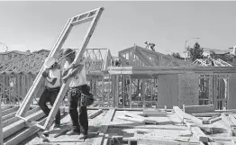  ?? Tribune News Service file photo ?? Workers put the framing up on luxury homes in Los Angeles in 2014. Constructi­on is among the industries that have made significan­t use of the H-2B program.