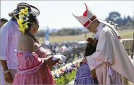  ?? ALESSANDRA TARANTINO / ASSOCIATED PRESS ?? A child embraces Pope Francis during a Mass on Wednesday at the Maquehue air base in Temuco, Chile. About 150,000 people attended.
