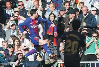  ?? FRANCISCO SECO / AP ?? Lionel Messi leaps in celebratio­n after netting from the penalty spot in Barcelona’s 3-0 win over Real Madrid at Santiago Bernabeu Stadium on Saturday. The victory sent Barca 14 points clear of Madrid at the top of La Liga.