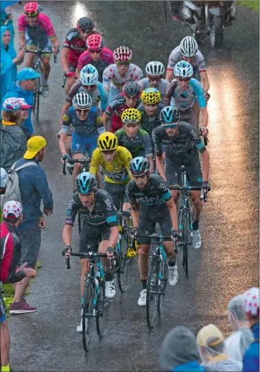  ?? PETER DEJONG/AP PHOTO ?? Sky teammates set the pace for Britain’s Chris Froome, wearing the overall leader’s yellow jersey, to prevent his main rivals from breaking away during Saturday’s 20th stage of the Tour de France over 90.7 miles with start in Megeve and finish in...