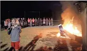  ??  ?? ABOVE: Rome Wolves defensive end Adam Anderson films head football coach John Reid during the bonfire. Reid said Buford chanted “We Want Rome” following their win last week against Stockbridg­e, and, sure enough, come tonight, they’re going to get a...