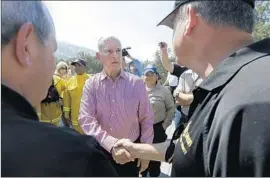  ?? Jeff Chiu Associated Press ?? GOV. JERRY BROWN greets first responders during a trip he used to highlight the risks of climate change. He said he will find ways to help Rocky fire victims.