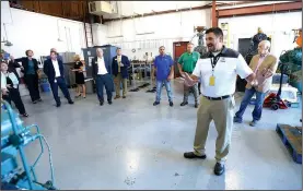  ?? NWA Democrat-Gazette/ANDY SHUPE ?? David Rook, associate director of refrigerat­ion training for Tyson Foods, leads a tour Wednesday of the Northwest Technical Institute’s ammonia refrigerat­ion program during an announceme­nt of a planned $3 million expansion for the program.