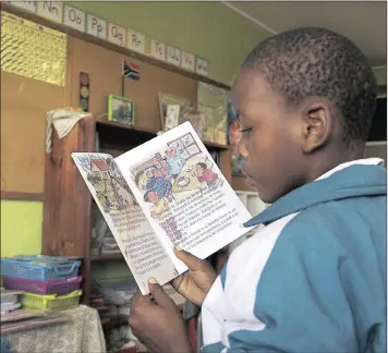  ??  ?? LEARNING FAST: A child practises reading skills through a Breakthrou­gh to Literacy reader.