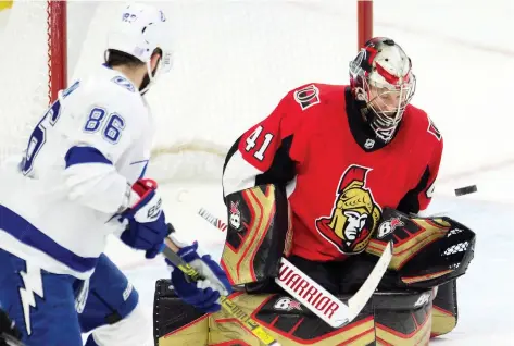  ?? ADRIAN WyLD/THE CANADIAN PRESS ?? Senators goalie Craig Anderson makes a save as Tampa Bay Lightning winter Nikita Kucherov looks for a rebound during last weekend’s game in Ottawa. When the two teams meet again today, expect Anderson to face another barrage of shots.
